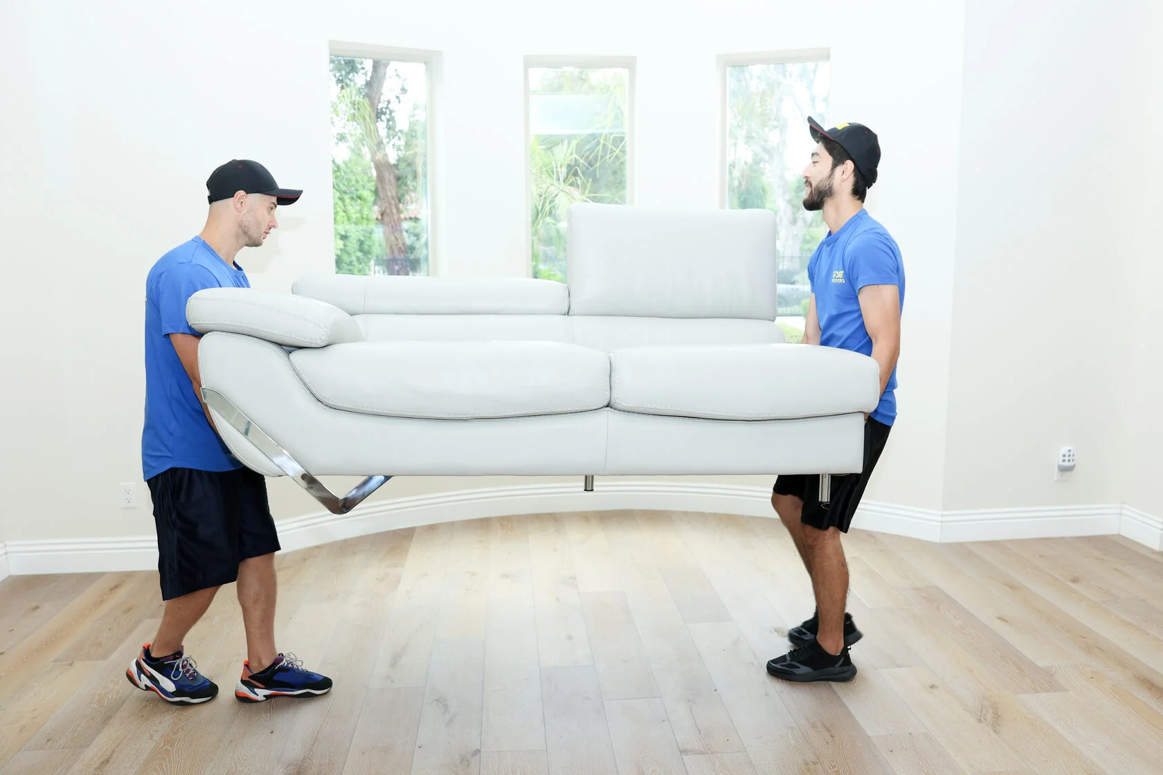 GOAT Movers carrying sofa
